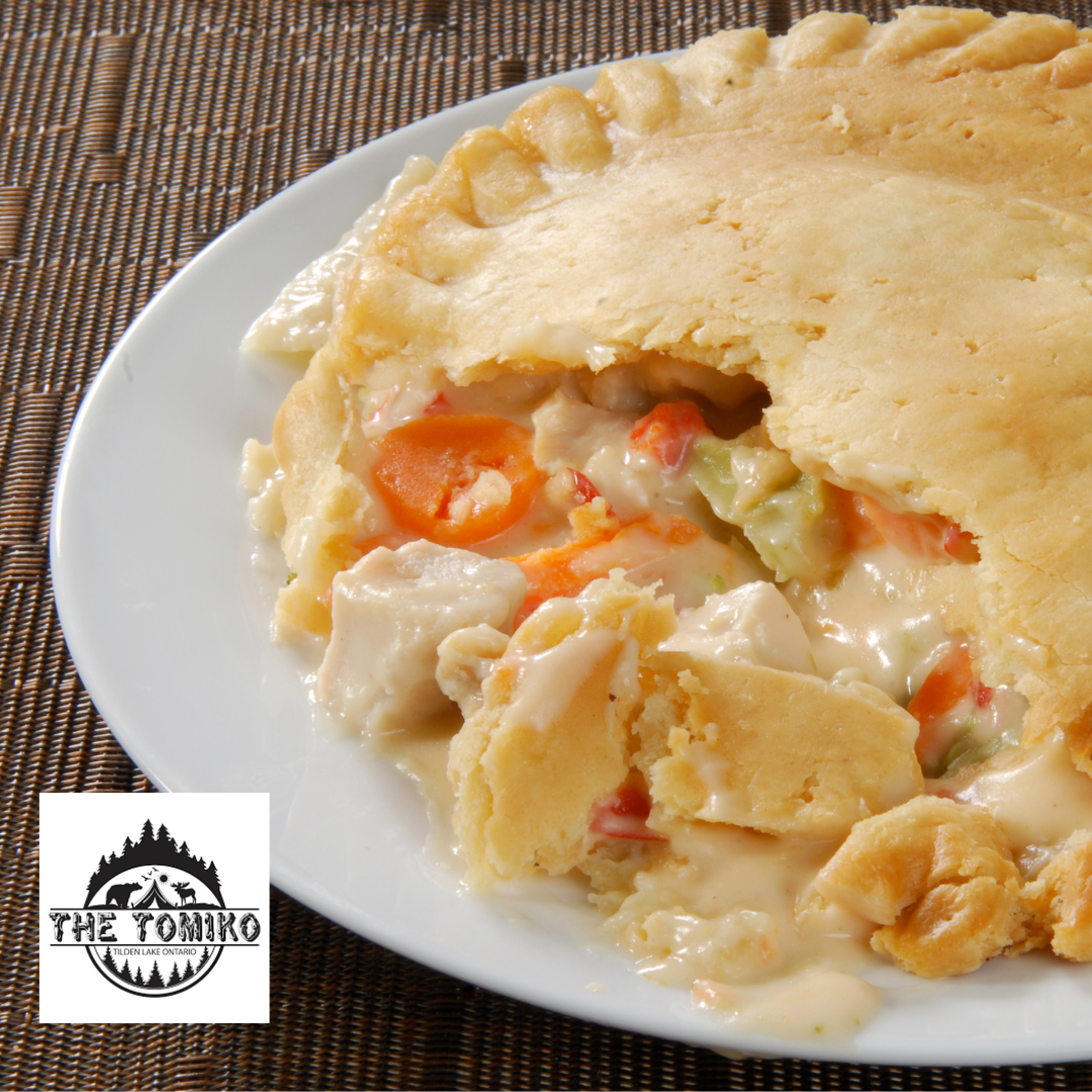 Chicken pot pie on a white plate with visible branding of 'The Yomiko'.