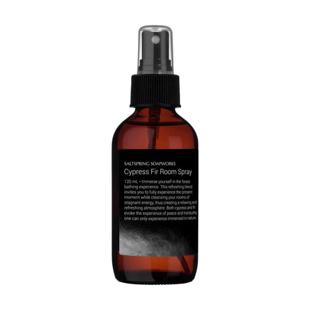 Brown glass spray bottle with black cap on a white background