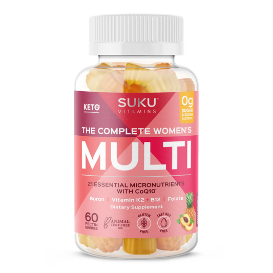 Clear bottle of SUKU Vitamins "The Complete Women's Multi" with a pink label. Contains 60 peach and pineapple-flavored pectin gummies. Label highlights key ingredients like Boron, Vitamin K2, B12, Folate, and CoQ10, along with features like gluten-free, nut-free, and sugar-alcohol-free.
