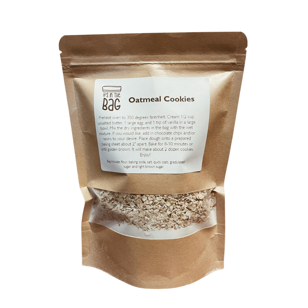 Brown paper bag with oatmeal cookies and recipe label on a white background