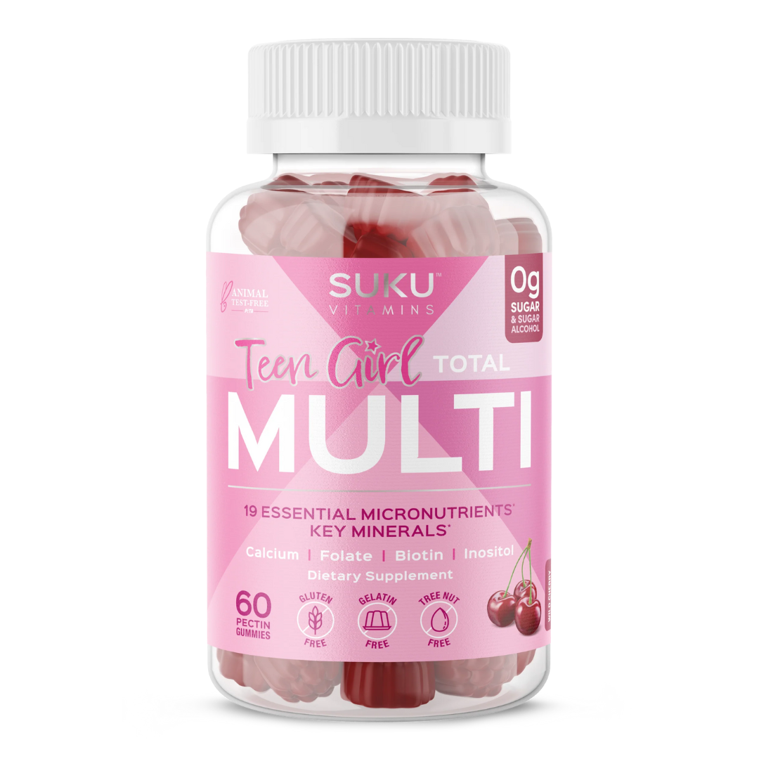 Bottle of SUKU Vitamins "Teen Girl Total Multi" with a pink label. Contains 60 wild cherry-flavored pectin gummies. Features 19 essential micronutrients and key minerals including calcium, folate, biotin, and inositol. Gluten-free, gelatin-free, nut-free, and sugar-free.