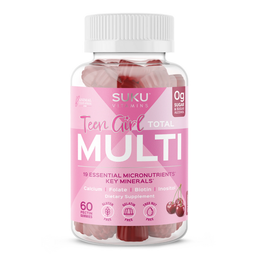 Bottle of SUKU Vitamins "Teen Girl Total Multi" with a pink label. Contains 60 wild cherry-flavored pectin gummies. Features 19 essential micronutrients and key minerals including calcium, folate, biotin, and inositol. Gluten-free, gelatin-free, nut-free, and sugar-free.