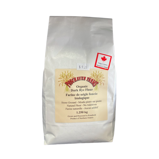 Bag of organic dark rye flour with a label on a white background