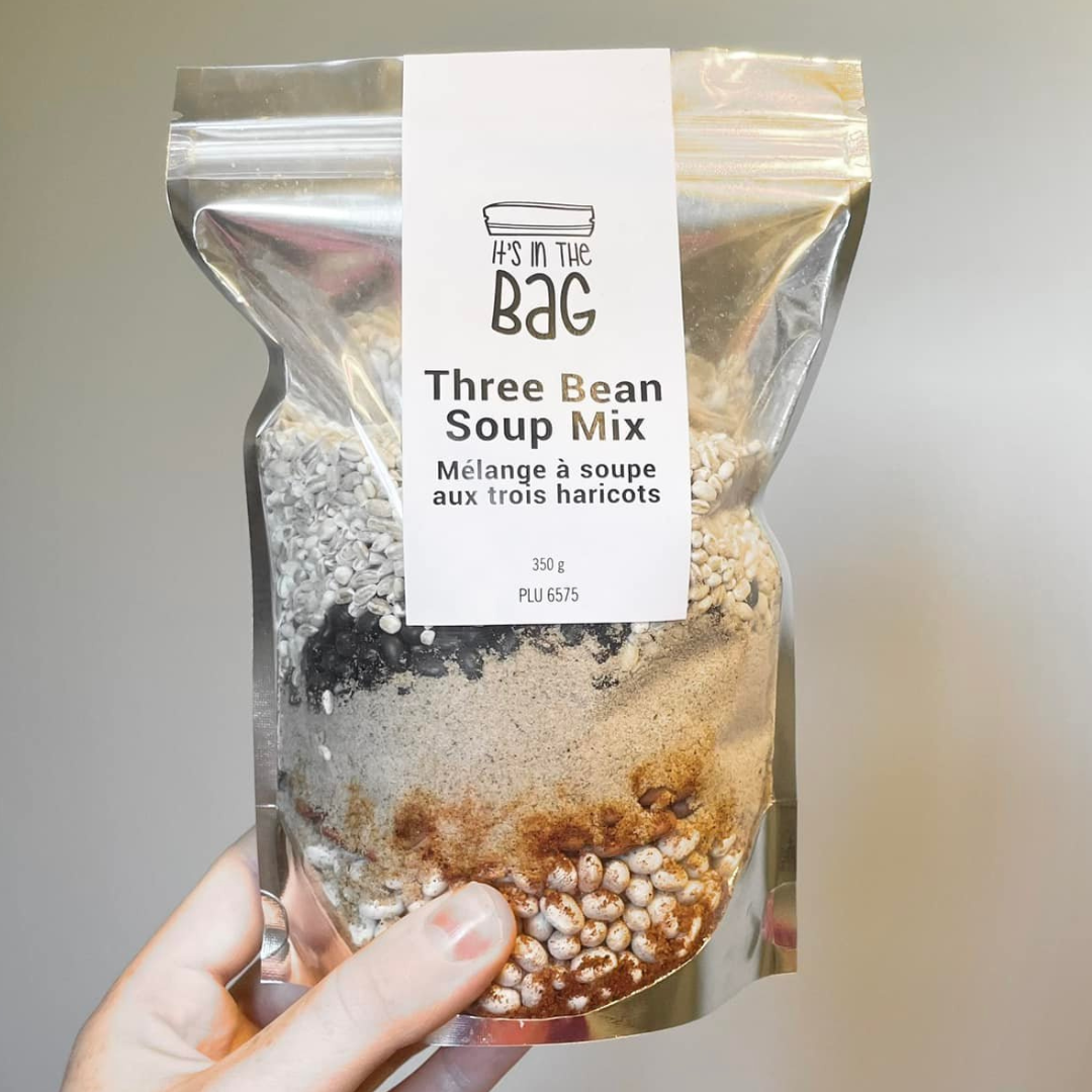 Three Bean Soup Mix package held by a hand with a neutral background