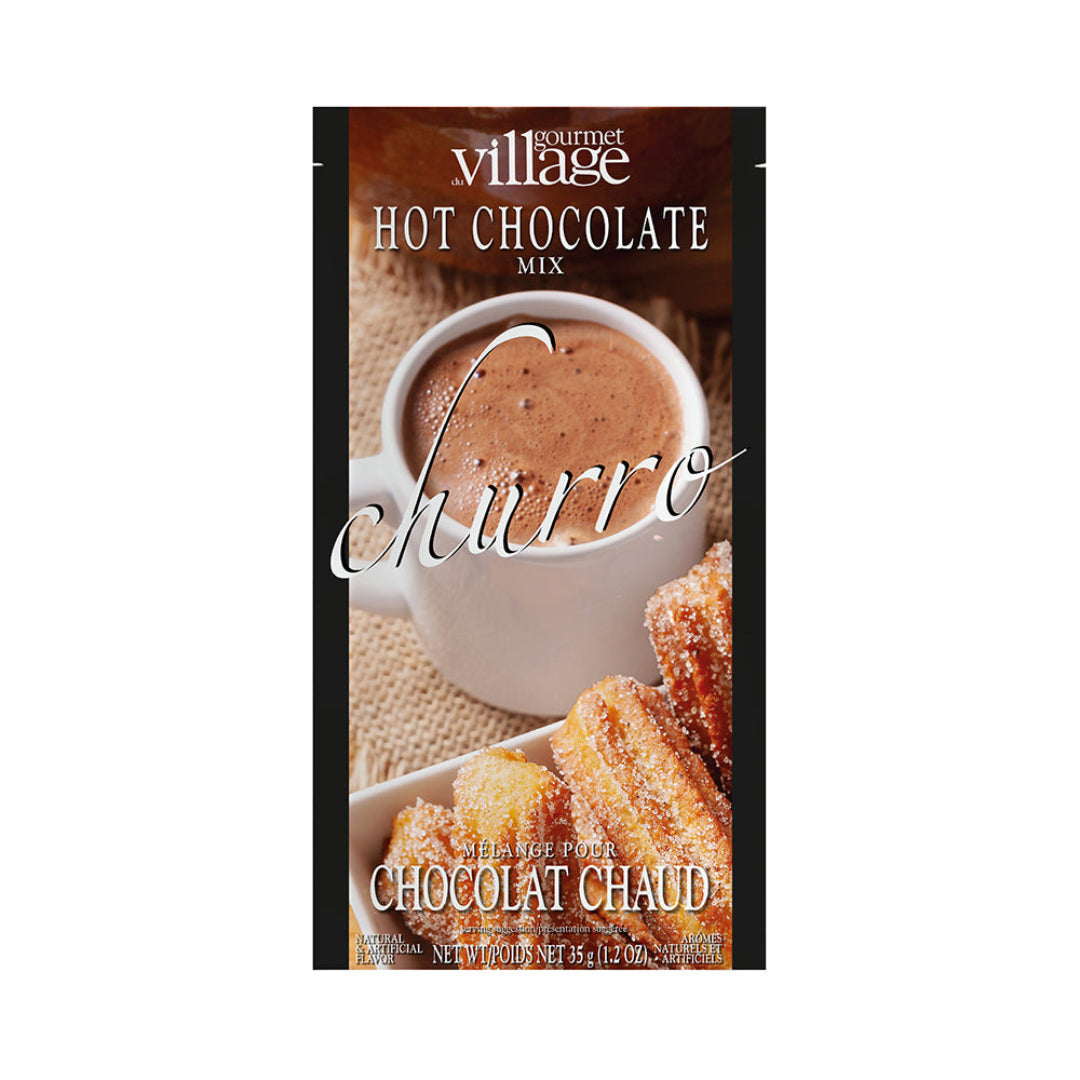 Gourmet Village Churro hot chocolate mix packaging with a cup of hot chocolate and cookies.