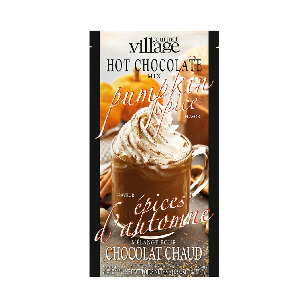 Packaging of Gourmet Village Pumpkin Spice hot chocolate mix with a cup of hot chocolate and pumpkins in the background.