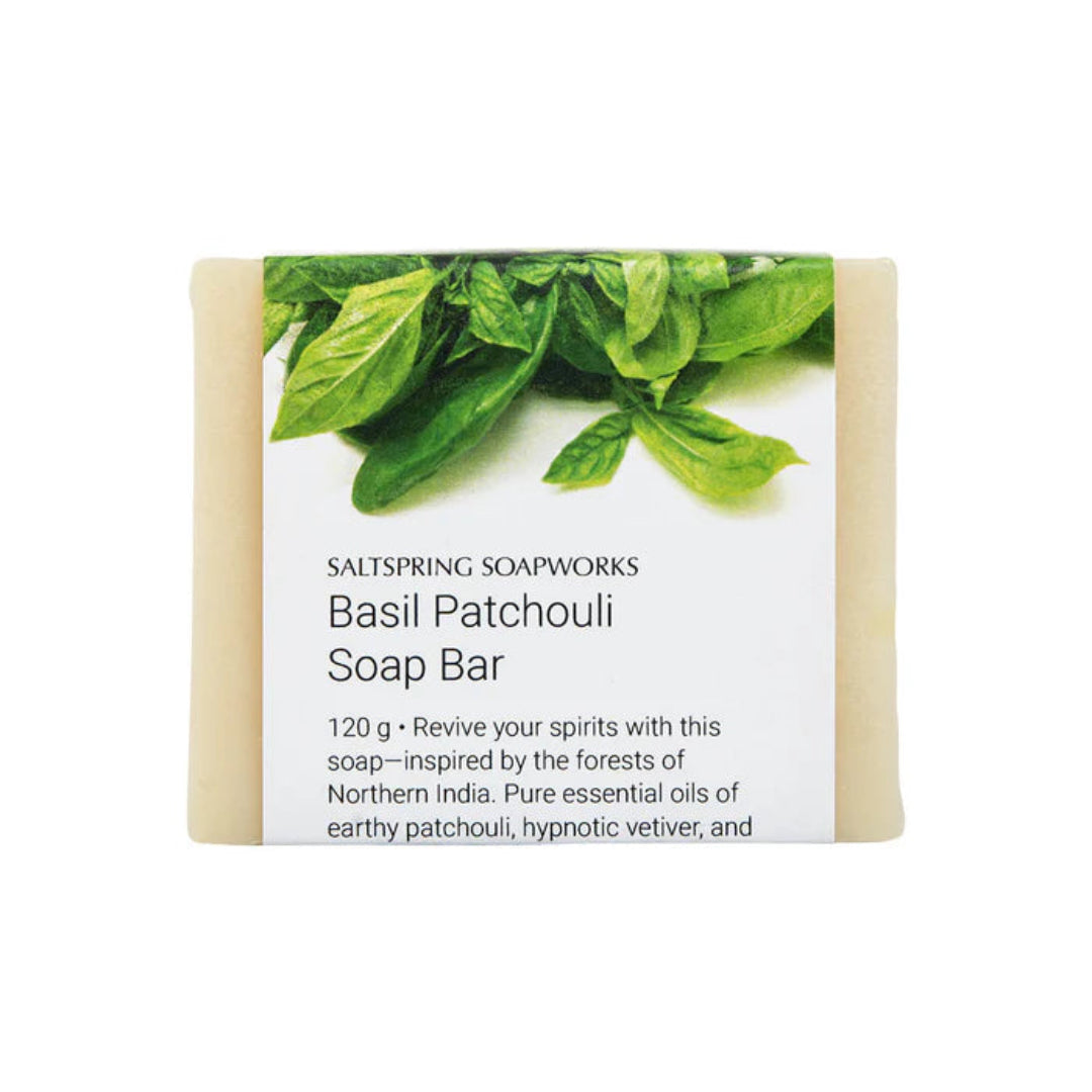 Basil Patchouli soap bar with green leaves on a white background