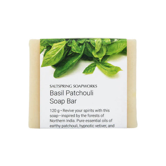 Basil Patchouli soap bar with green leaves on a white background